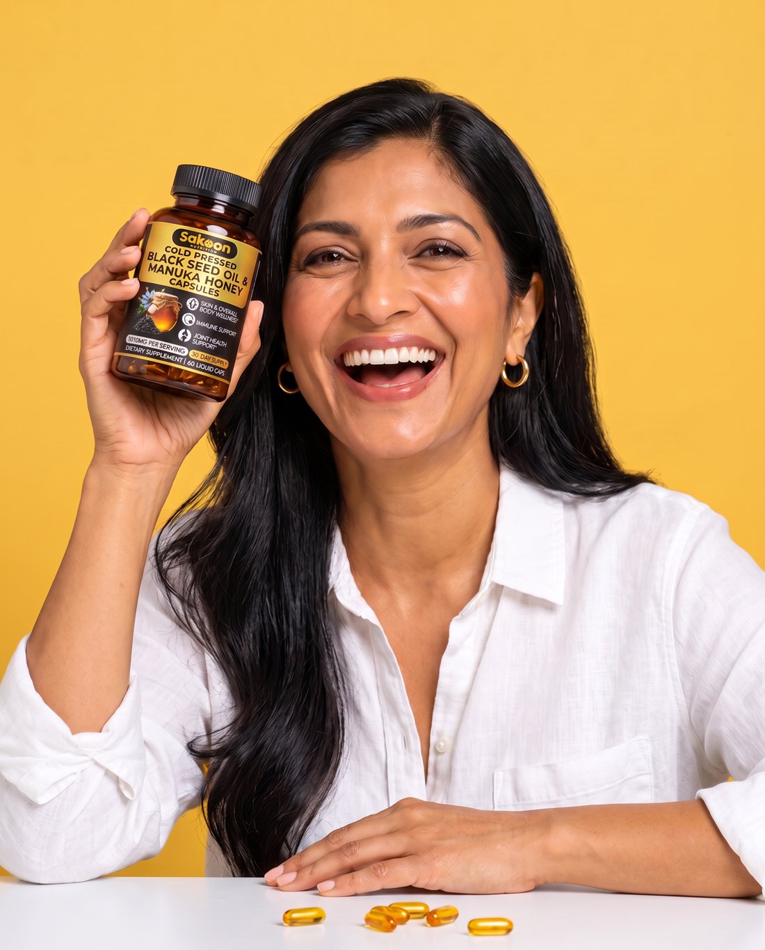 Woman in her late thirties holding the Sakoon Black Seed Oil and Manuka Honey Capsules bottle in her bathroom