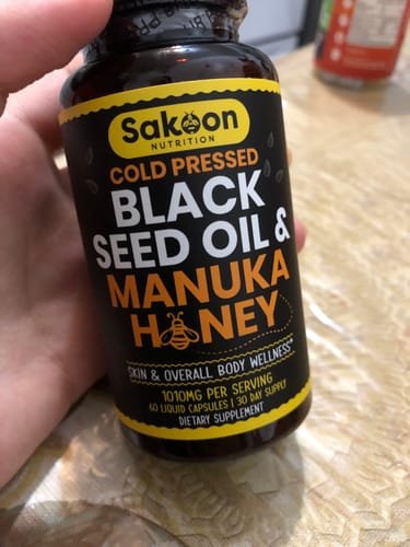 Customer holding the capsules bottle